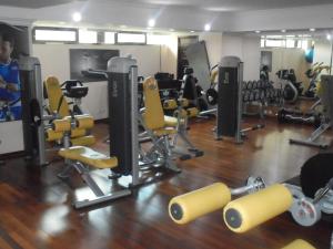 a gym with yellow chairs and equipment on a wooden floor at Saro Maria Hotel in Addis Ababa