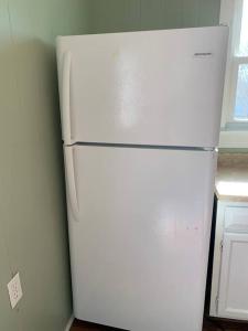 a white refrigerator in the corner of a kitchen at Chic Home Away From Home! in Bowling Green