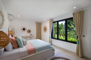 a bedroom with a bed and a large window at Gorgeous Villa Fizia in Bingin Center in Uluwatu +23 photos