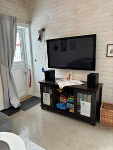 a living room with a flat screen tv on a wall at Marmorcafets B&B in Kolmården