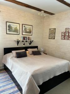 a bedroom with a large white bed in a room at Marmorcafets B&B in Kolmården