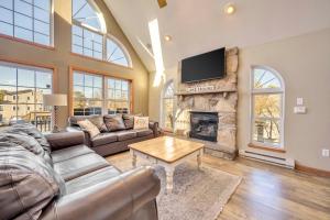 a living room with a couch and a fireplace at Pocono Pinnacle by AvantStay Steps to the Lake Game Room Large Deck in Albrightsville
