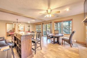 a kitchen and dining room with a table and chairs at Pocono Pinnacle by AvantStay Steps to the Lake Game Room Large Deck in Albrightsville