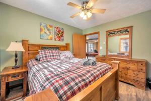 a bedroom with a bed and a dresser and a mirror at Pocono Pinnacle by AvantStay Steps to the Lake Game Room Large Deck in Albrightsville