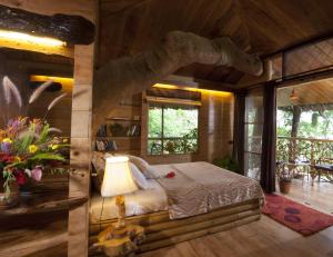 a bedroom with a bed in a log cabin at Tranquil Resort - Blusalzz Collection, Wayanad - Kerala in Ambalavayal +147 photos
