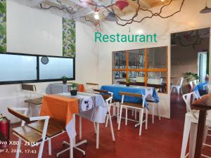 a restaurant with tables and chairs and a sign that reads restaurant at Ani Marie Guest House in Coron