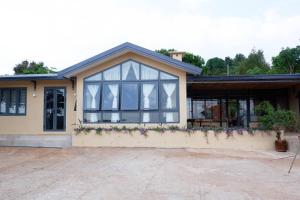 una casa con muchas ventanas en Thom Farm and Retreat en Teurnoun