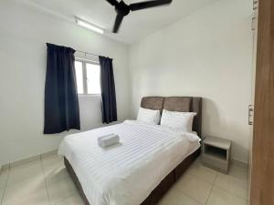 a bedroom with a large white bed with blue curtains at Alanis by MOKA at SEPANG in Sepang +22 photos