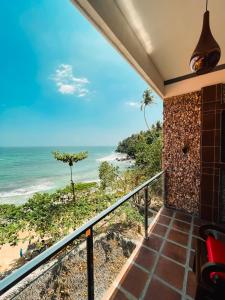 a balcony with a view of the beach at Coral Beach Hotel in Mirissa