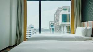 Holiday Inn Express Singapore Katong by IHG客房内的一张或多张床位