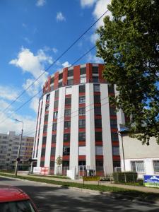 a tall white and red building on a street at Ubytovací zařízení Koleje Pedagog in České Budějovice