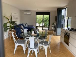 a kitchen and living room with a glass table and chairs at McCrae Beach Front Villa Unit 1 in McCrae