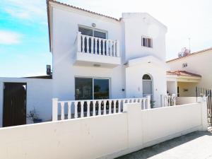 a white house with a white fence at Villa Lankas with Heated pool in Ayia Napa