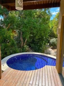 a small pool sitting on a wooden deck at Bangalô Villas do Pratagy in Maceió