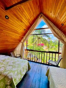 a bedroom with a bed and a large window at Green Paradise Bungalows in Las Palmas
