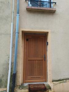 une porte en bois sur le côté d'un bâtiment dans l'établissement chambre indépendante avec SDB privative, à Maron