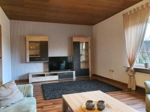 Televisyen dan/atau pusat hiburan di Holiday home Nordseeglück