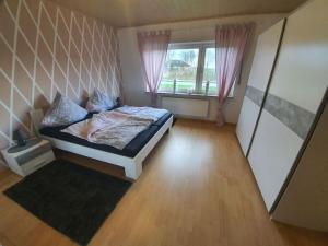 Katil atau katil-katil dalam bilik di Holiday home Nordseeglück