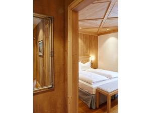a small bedroom with a bed and a mirror at Suite Beech Modern retreat in Bad Wiessee