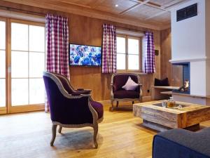 a living room with two chairs and a coffee table at Suite Beech Modern retreat in Bad Wiessee