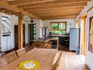 a kitchen with a table and a clock on the wall at House by the Park Modern retreat in Bispingen