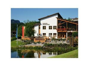 a large white building with a pond in front of it at 1 Porzig Modern retreat in Fischen