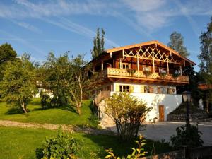 a house with a balcony on the side of it at Suite Linde Modern retreat in Bad Wiessee