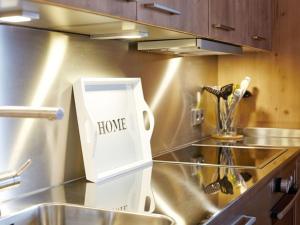 a kitchen with a home sign on the counter at Suite Linde Modern retreat in Bad Wiessee