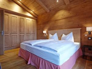 a bedroom with a large bed in a wooden room at Suite Linde Modern retreat in Bad Wiessee