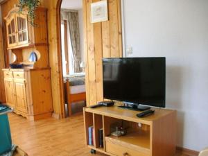 a television on a wooden stand in a living room at Bärenhüsli No 7 in Titisee