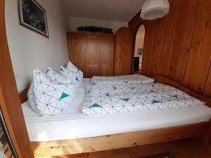 a bedroom with a bed with blue and white pillows at Bärenhüsli No 7 in Titisee