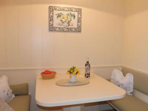 a table with a bottle of wine and flowers on it at Haus Hoppel - FeWo ground floor in Rantum