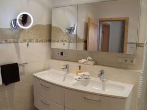 a bathroom with a sink and a mirror at Hochkalter - Reich family in Schönau am Königssee +21 photos