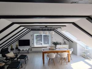 a living room with a table and chairs at See & So Modern Retreat in Winterberg