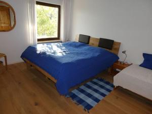 a bedroom with a blue bed and a window at Hanssen in Lindau Lake Constance in Lindau