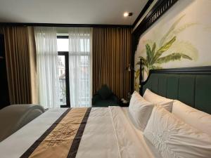a bedroom with a large bed and a window at Grand Hotel HN- by BAY LUXURY in Hanoi