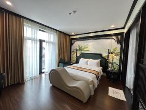 a bedroom with a large bed with a large painting on the wall at Grand Hotel HN- by BAY LUXURY in Hanoi