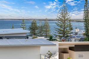 a view of the water from the balcony of a house at Kings Beachside Escape spacious apartment centrally located in Caloundra