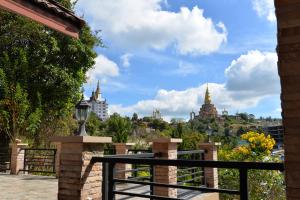 a view of the city from the balcony of a building at NiRVANA Khao Kho วิลล่าพักผ่อนสำหรับ 8 ท่าน ติดวัดผาซ่อนแก้ว เดิน 5 นาที สัมผัสบรรยากาศอบอุ่น เหมือนได้กลับมารวมตัวกันอีกครั้ง in Phetchabun +20 photos