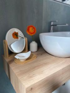 a bathroom counter with a bowl and a sink at Hotel Londra in Milano Marittima