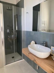 a bathroom with a large white sink and a shower at Hotel Londra in Milano Marittima