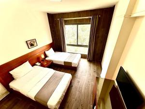 Voodi või voodid majutusasutuse Caesar's Park Hotel toas