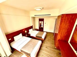 Voodi või voodid majutusasutuse Caesar's Park Hotel toas