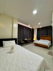 a large bedroom with two beds and a table at Florencia's Inn in Panglao