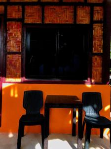 two chairs and a table with a large television at Don Leo's BnB in Esperanza +8 photos