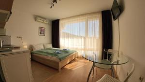 a small room with a glass table and a window at William's apartments - fifth amazing studio in Sveti Vlas +72 photos