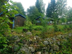 a garden with rocks in front of a house at Holiday home ODENSBACKEN IV in Stora Mellösa