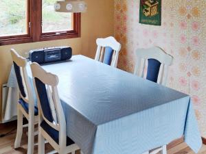 a dining room table with chairs and a blue table and a table and chairsktop at Holiday home ORNÖ II in Ornö