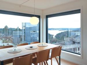 a dining room with a table and a large window at 6 person holiday home in Søndeled in Søndeled +22 photos