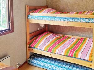 two bunk beds in a room with a window at Holiday home ORNÖ II in Ornö